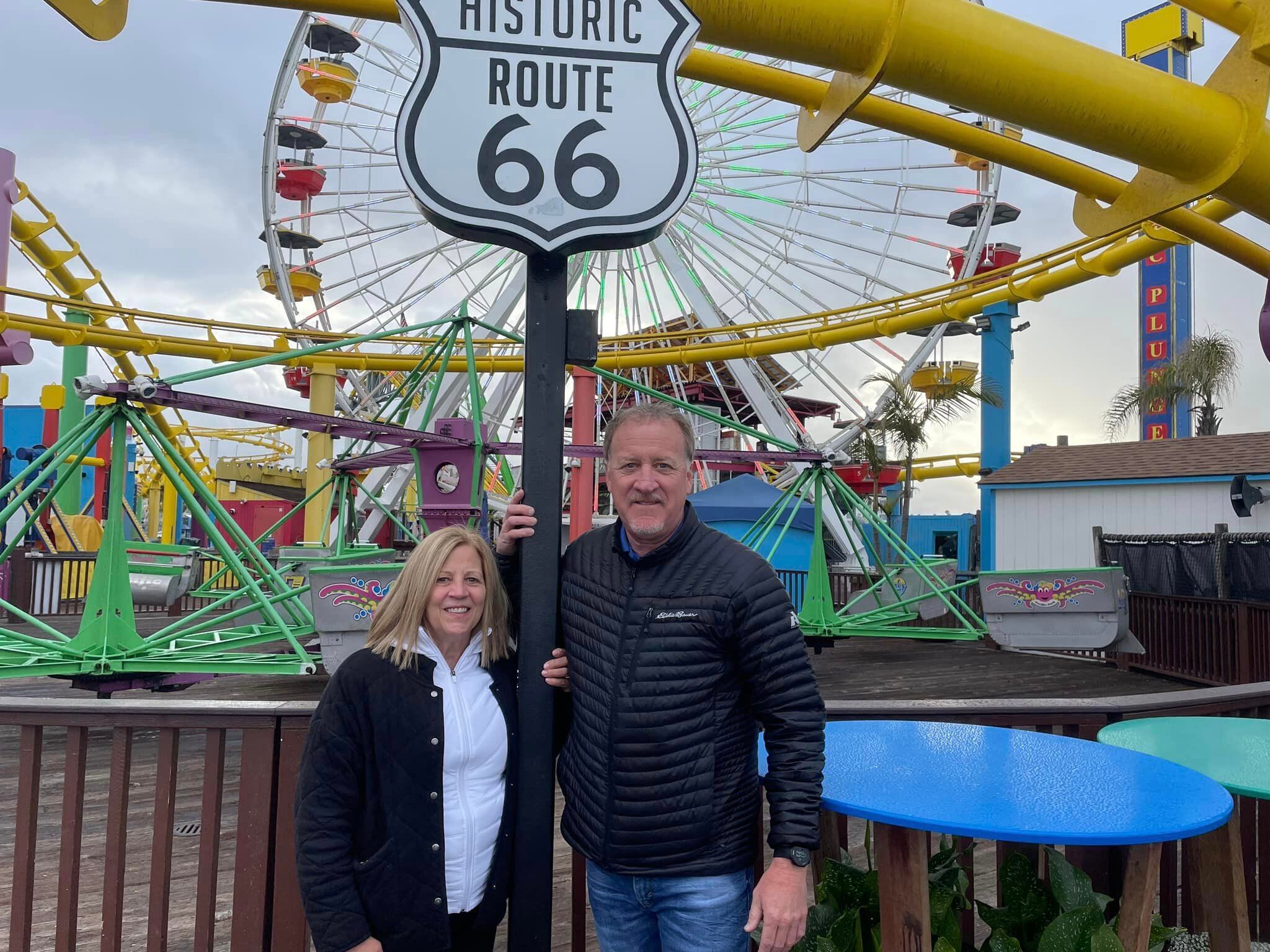 A Route 66 shield overlooks Santa Monica's pier amusement park. 