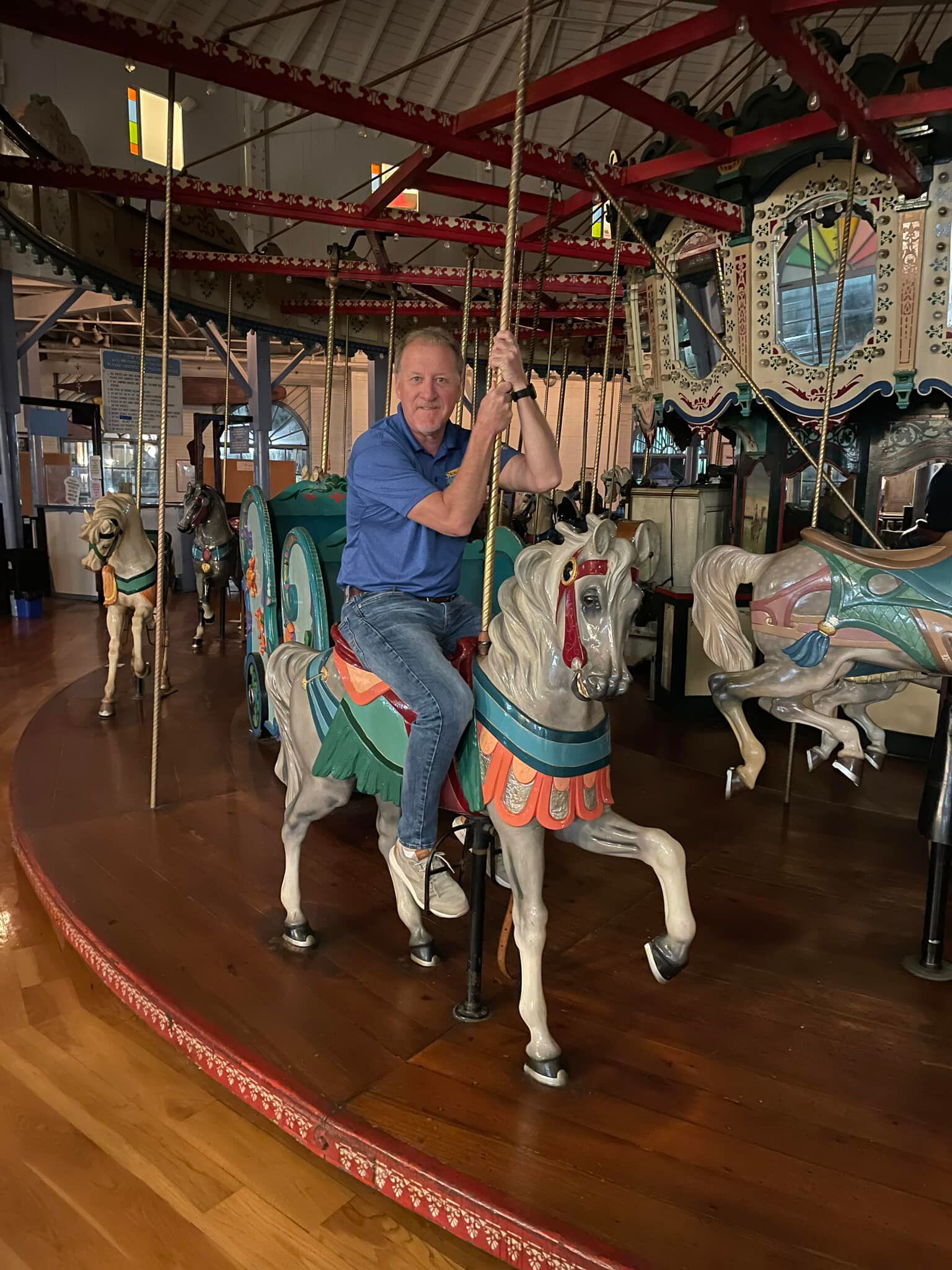 Slocum hops aboard the carousel. 