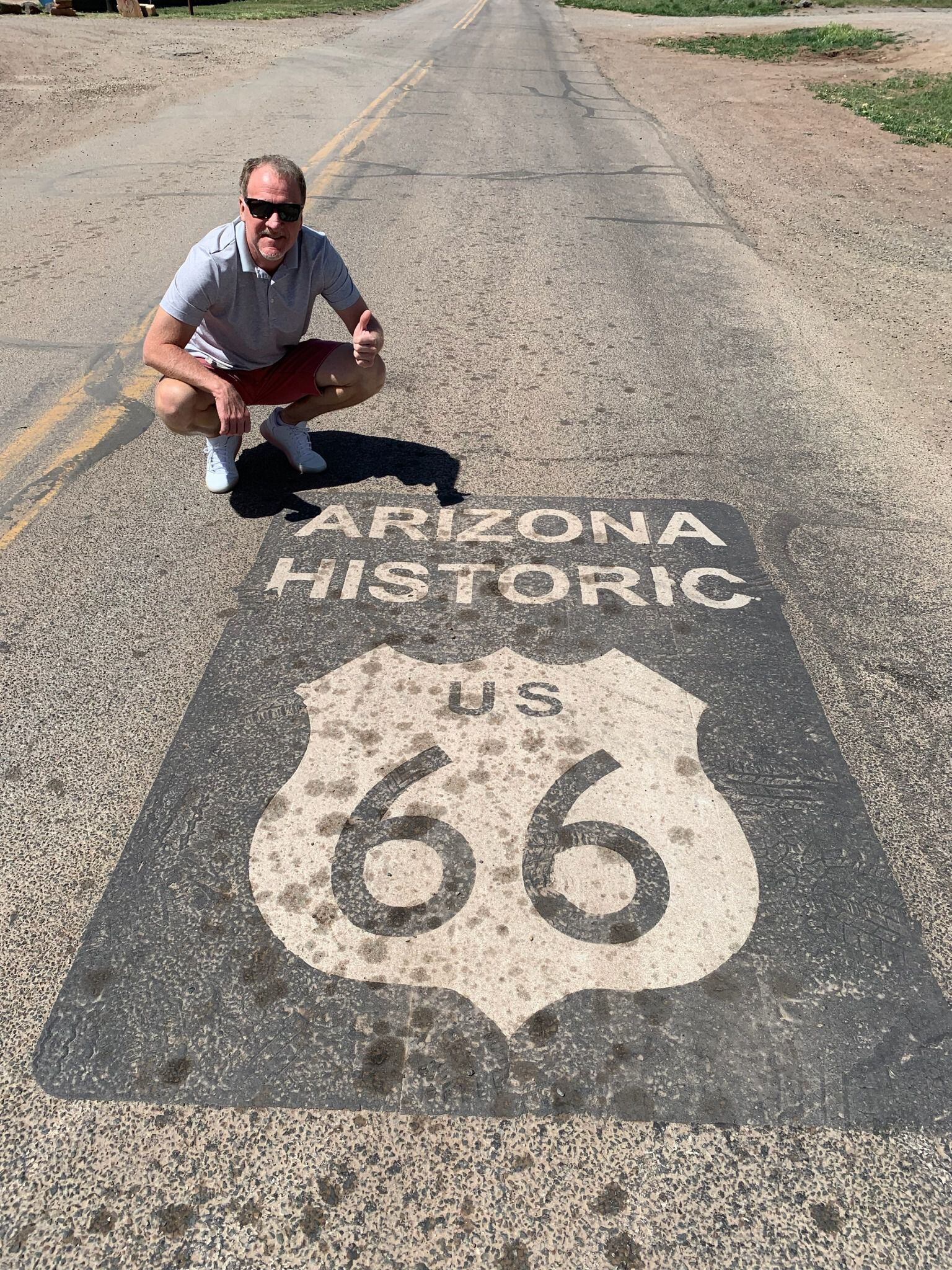 Scott poses with a painted shield, signifying an original stretch of Route 66.