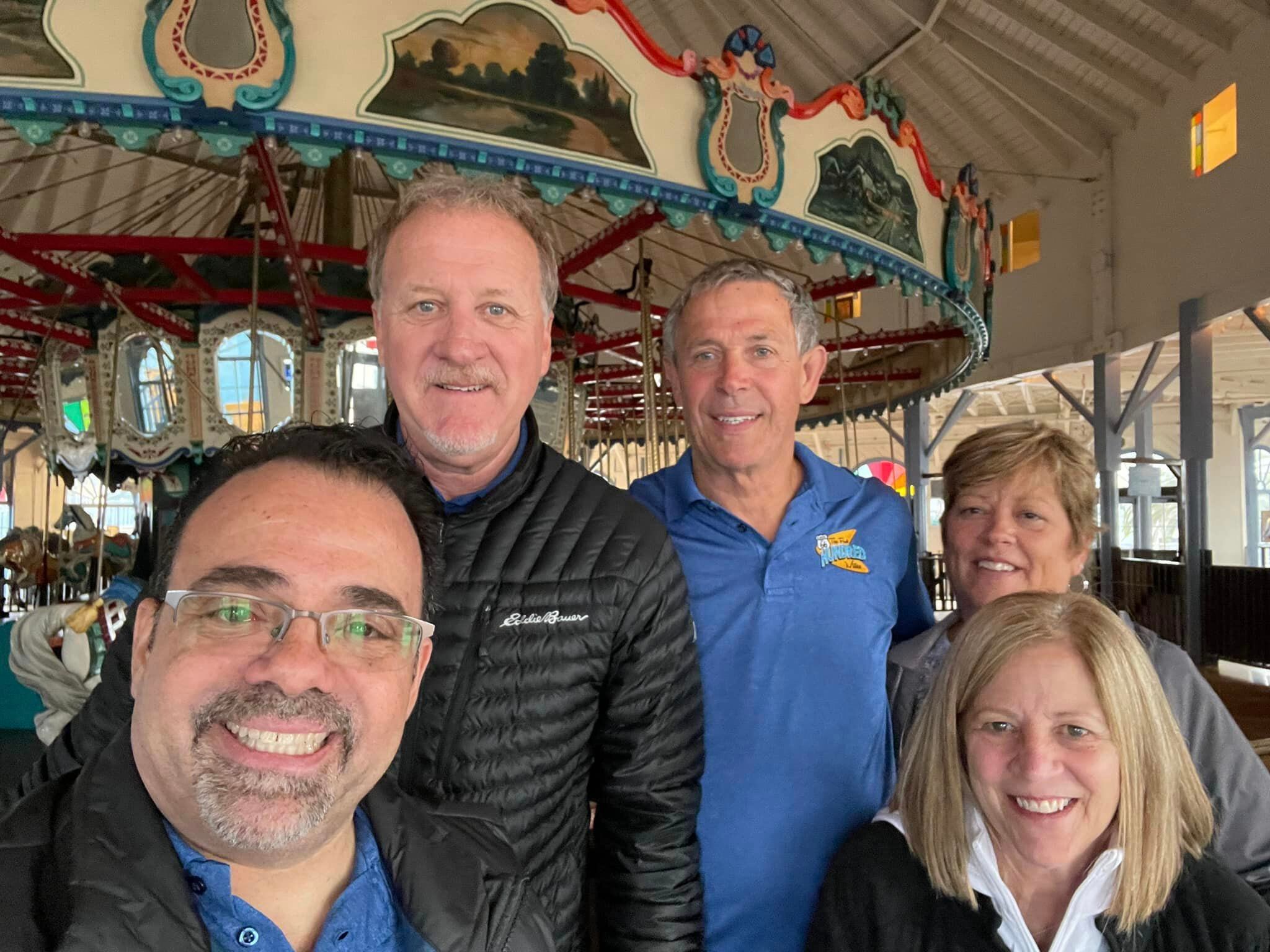 Bob Navarro of Heritage Corridor Destinations poses with the WJOL crew outside of the pier's carousel. 
