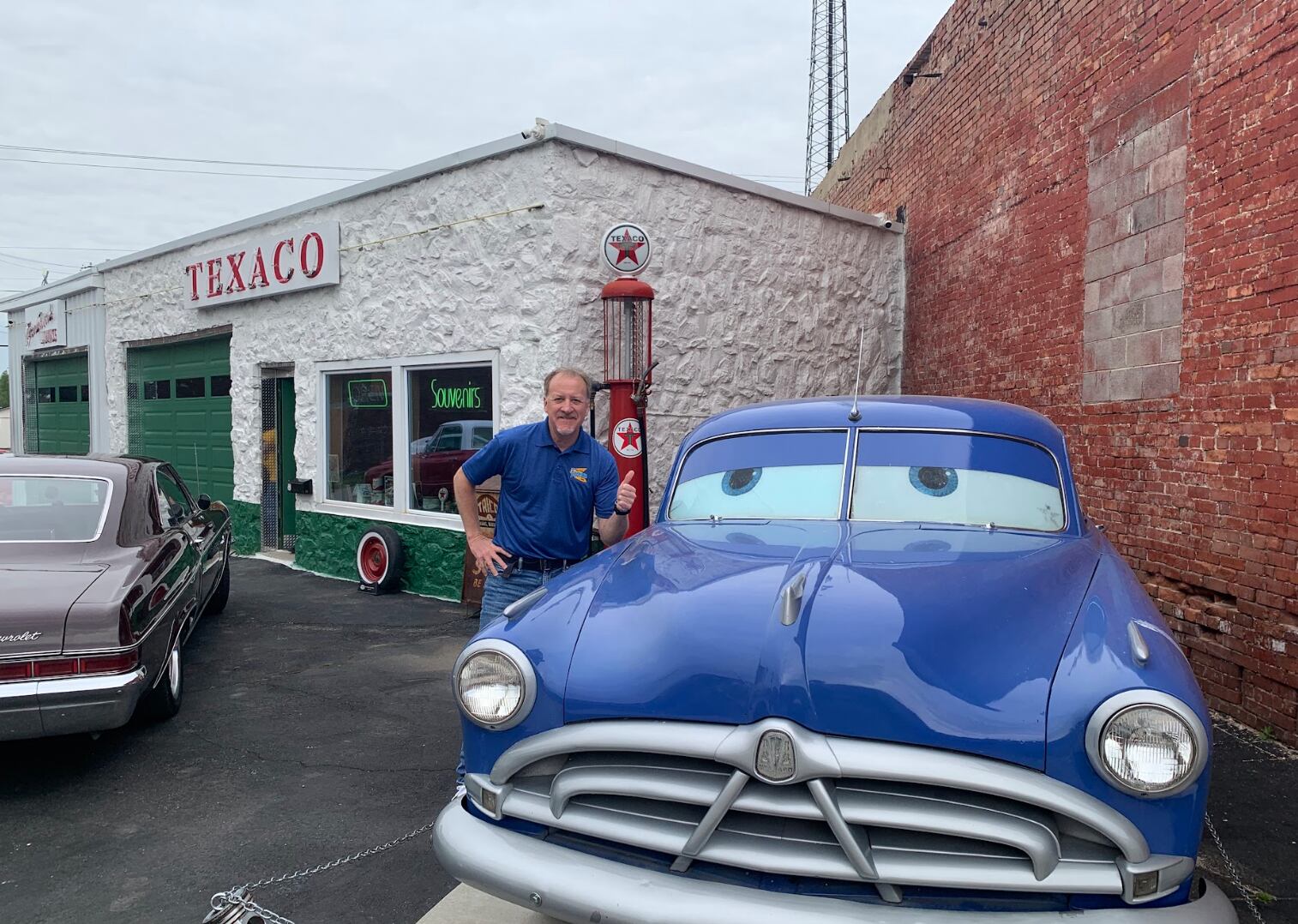 Scott poses with a life-sized recreation of Doc Hudson from the Pixar film 'Cars'